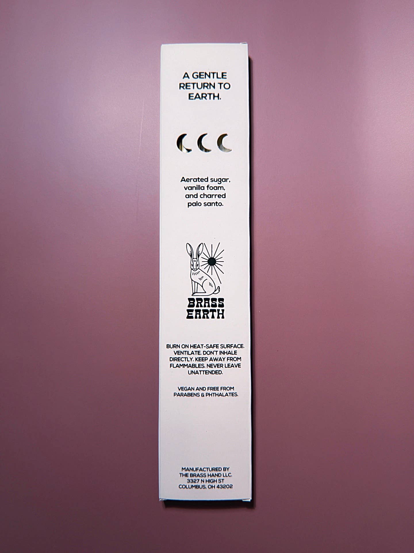 Brass Earth Product packaging with text and branding on a purple background