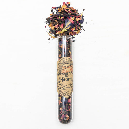 Colorful herbal tea in a glass tube with a label on a white background