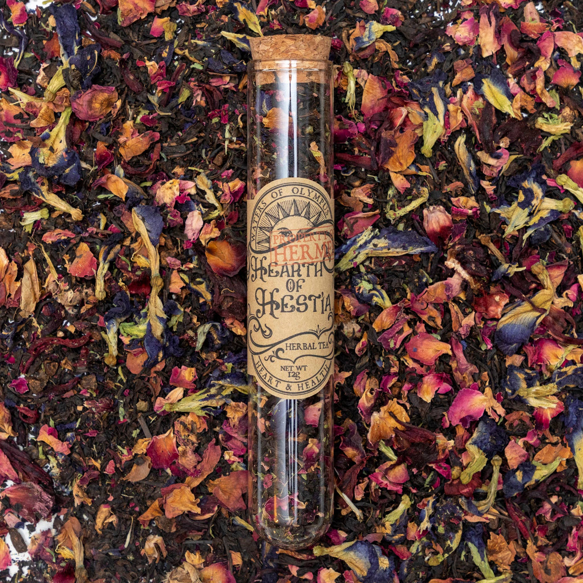 Herbal tea packaging with colorful dried herbs on a dark background