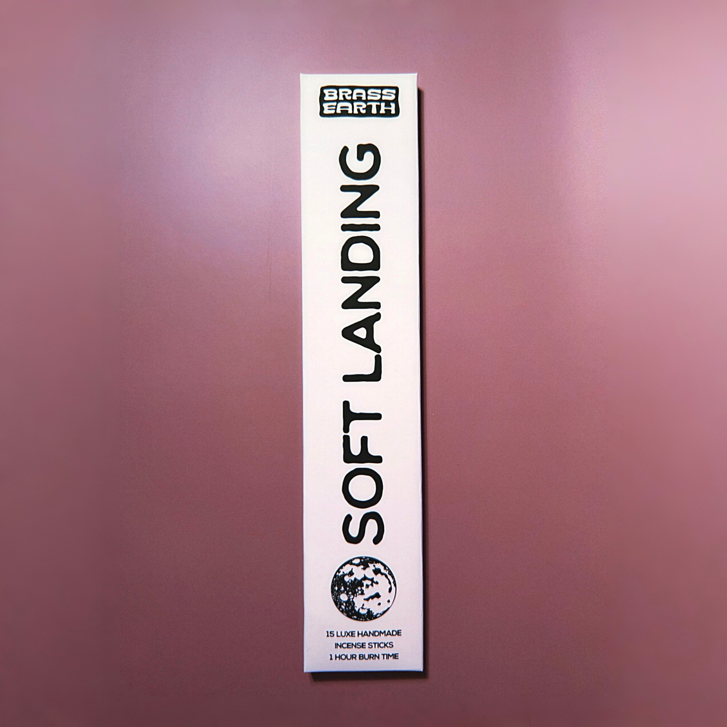 Incense packaging labeled 'Soft Landing' by Brass Earth on a purple background