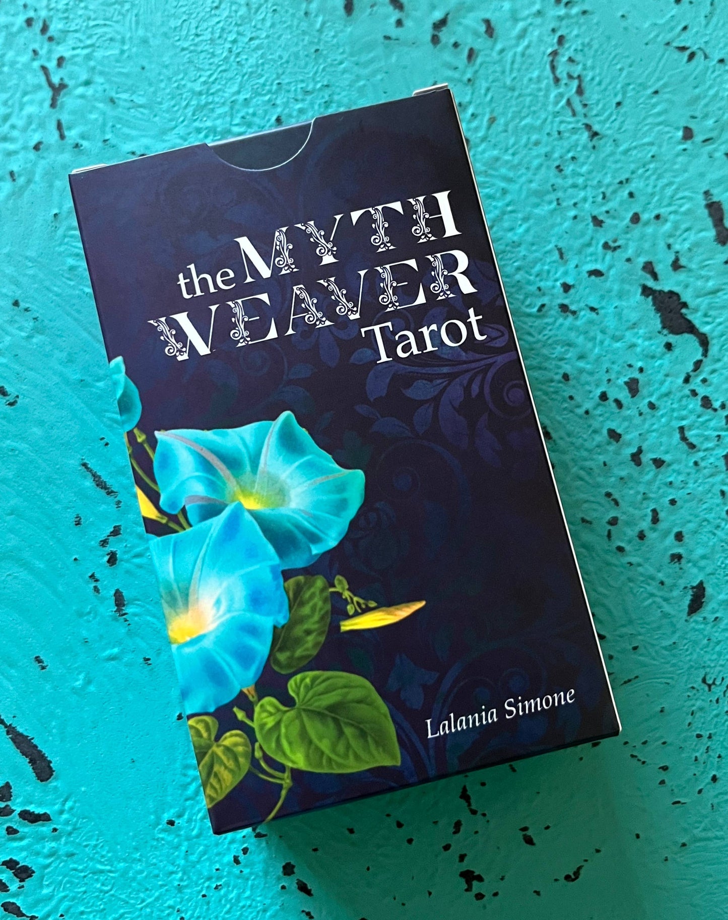 Tarot card box titled 'The Myth Weaver Tarot' by Lalania Simone on a textured blue background.