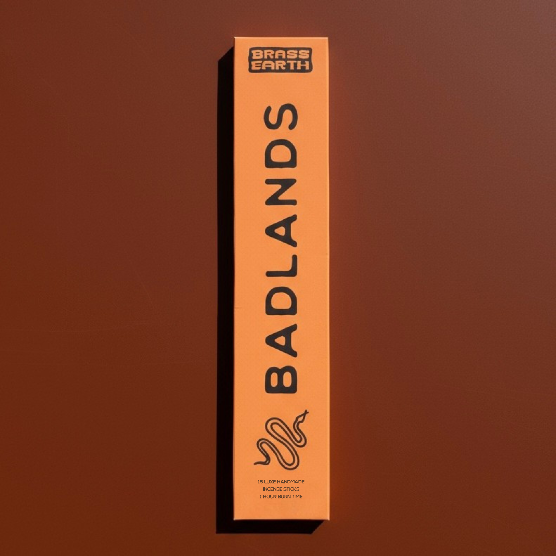Box of 'Badlands' incense by Brass Earth on a brown background