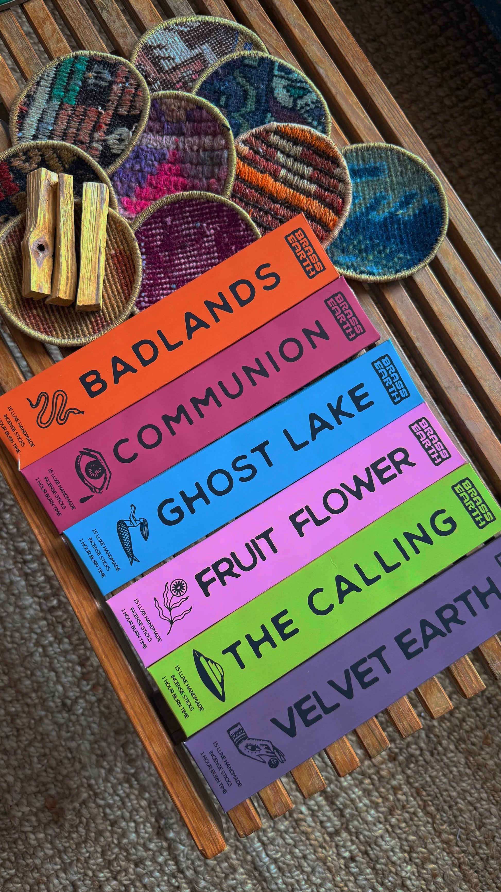 Colorful incense boxes with titles on a wooden surface