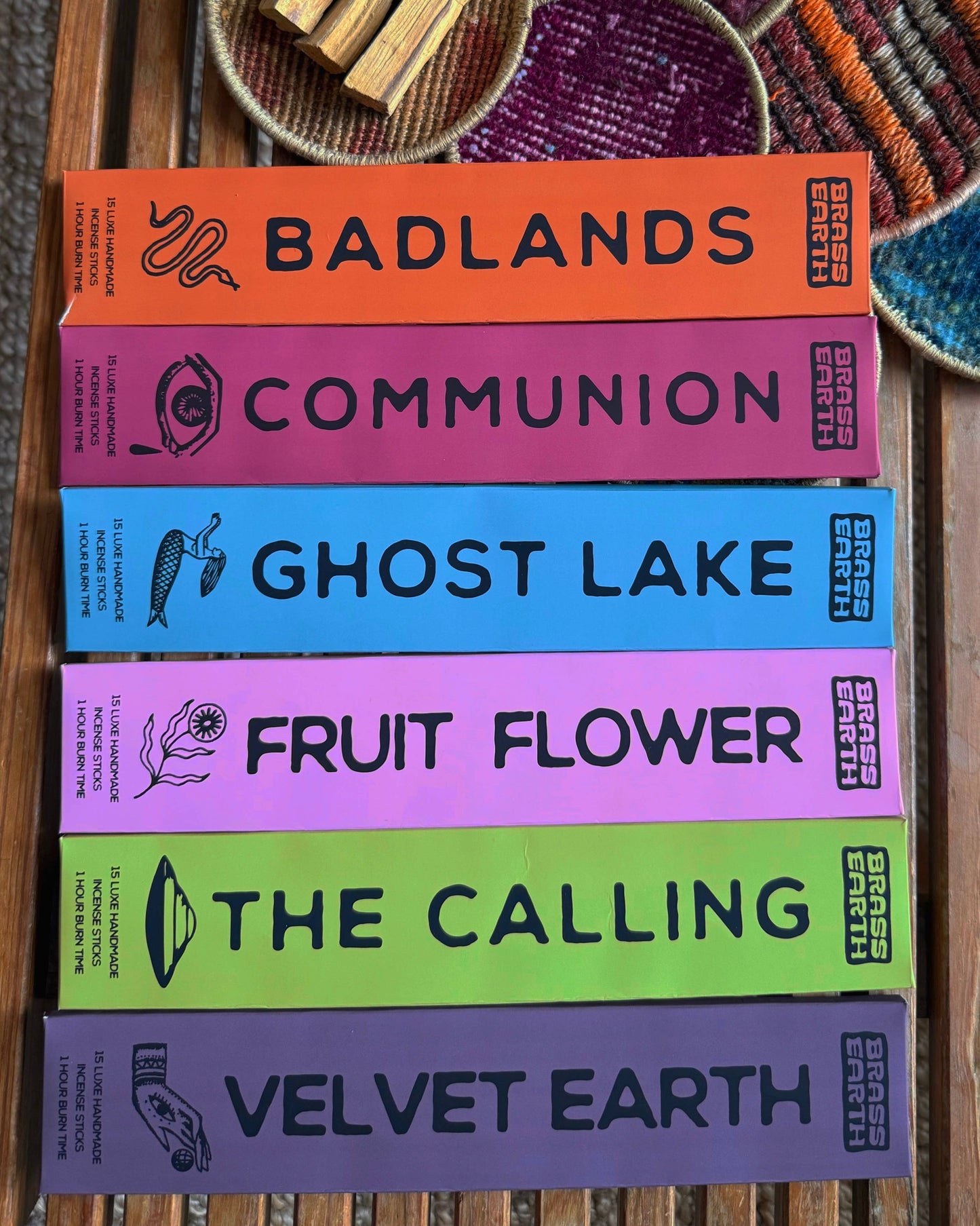 Stack of incense with colorful boxes on a wooden surface