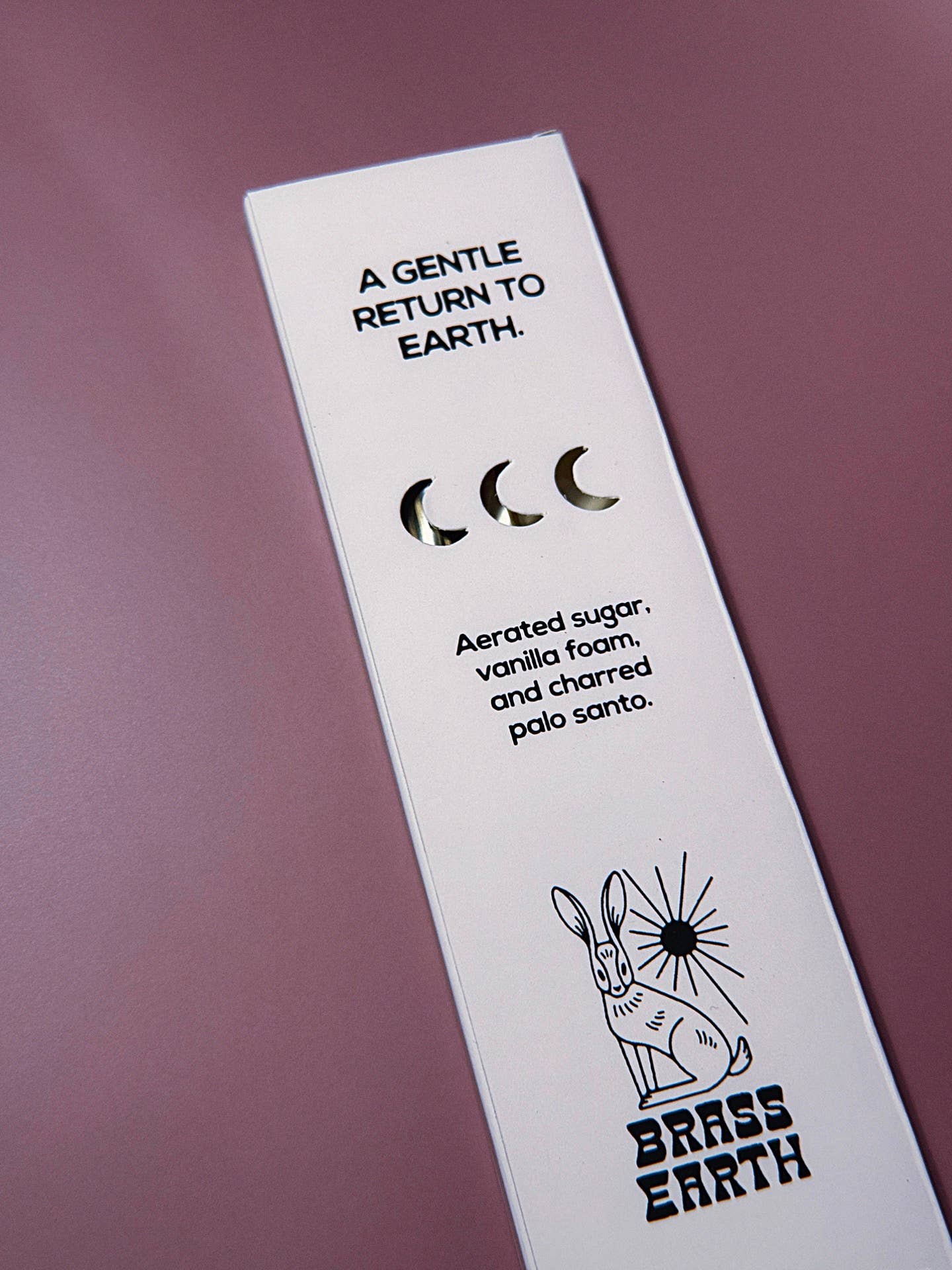 Brass Earth Product packaging with text and branding on a purple background