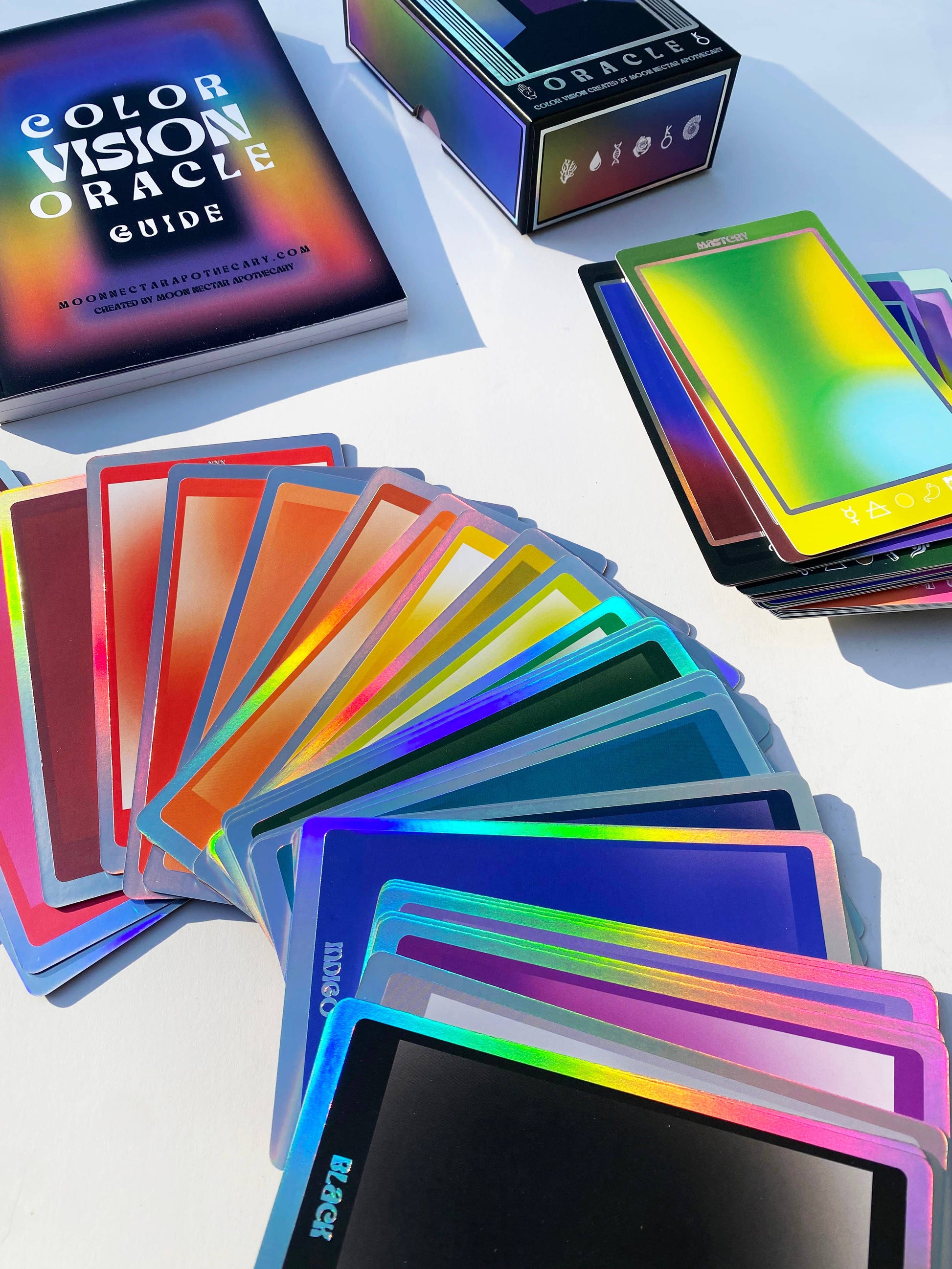Color vision oracle cards with a guidebook on a white surface
