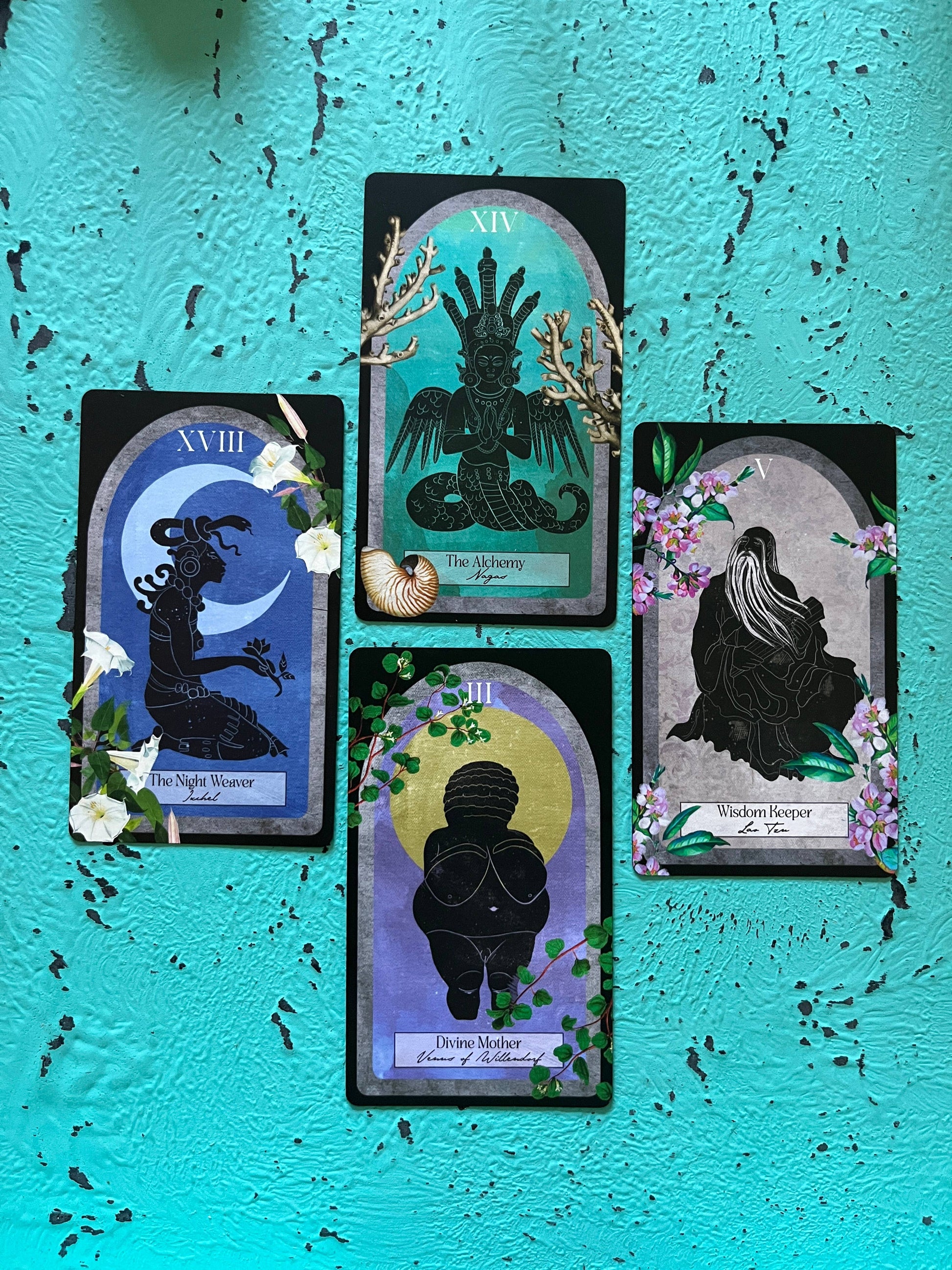 Set of tarot cards with silhouette designs on a textured blue background
