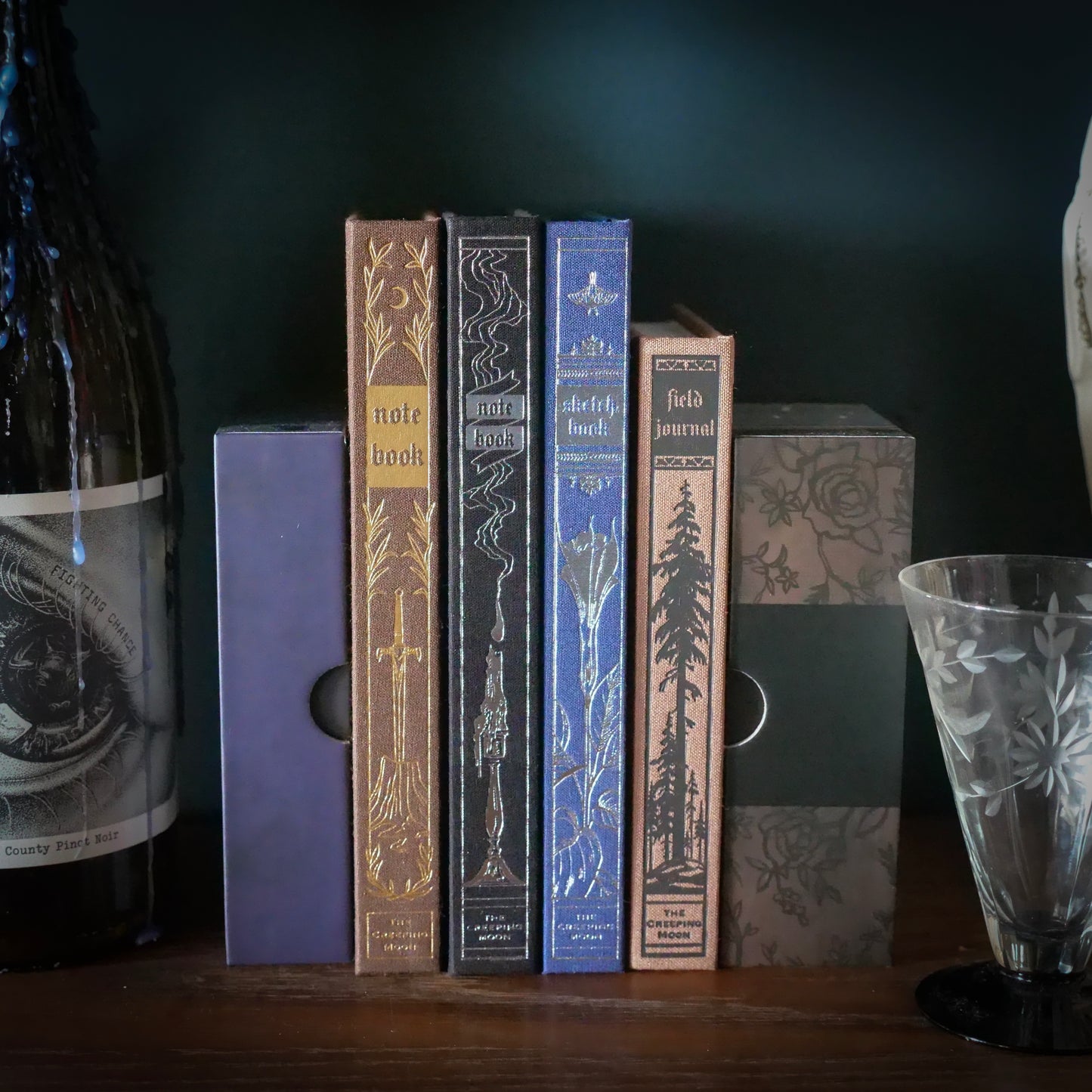 a row of notebook spines, surrounded by decorative items