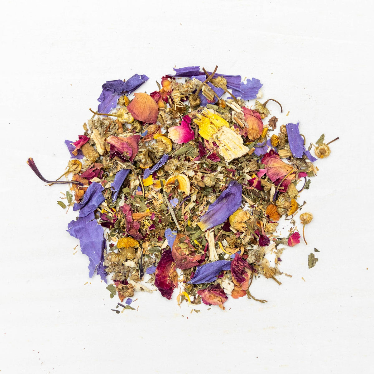 Colorful mix of dried flowers and herbs on a white background
