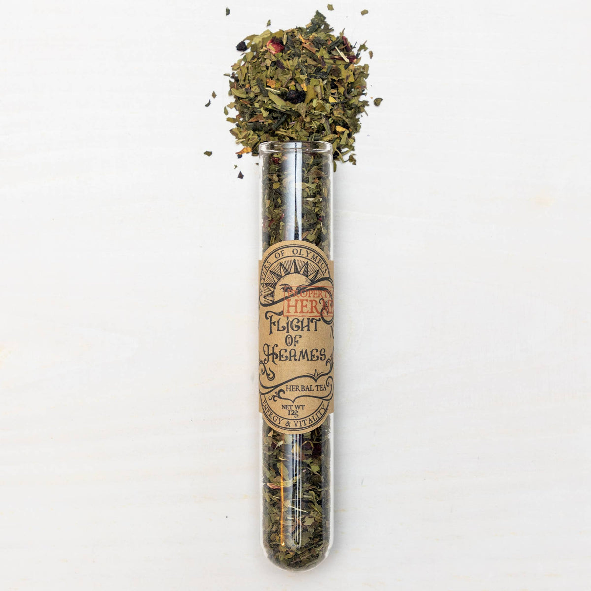 Test tube with dried herbs and a label on a white background