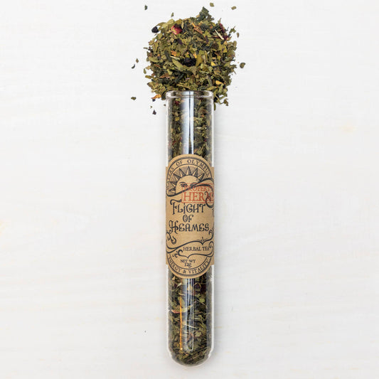 Test tube with dried herbs and a label on a white background