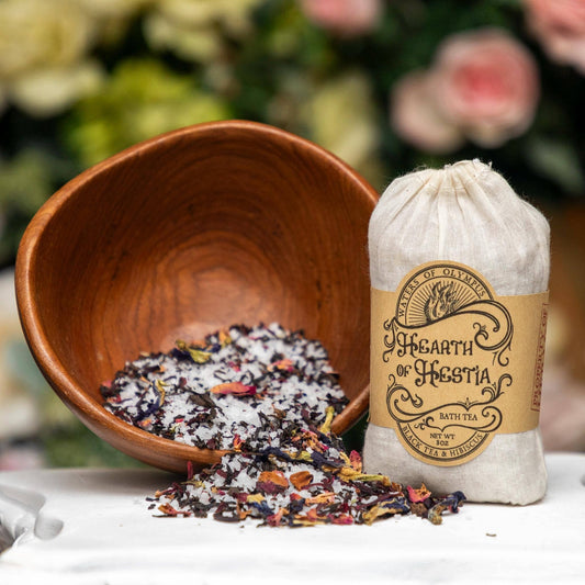 Bath tea packaging with a wooden bowl of bath salts and flowers on a blurred floral background