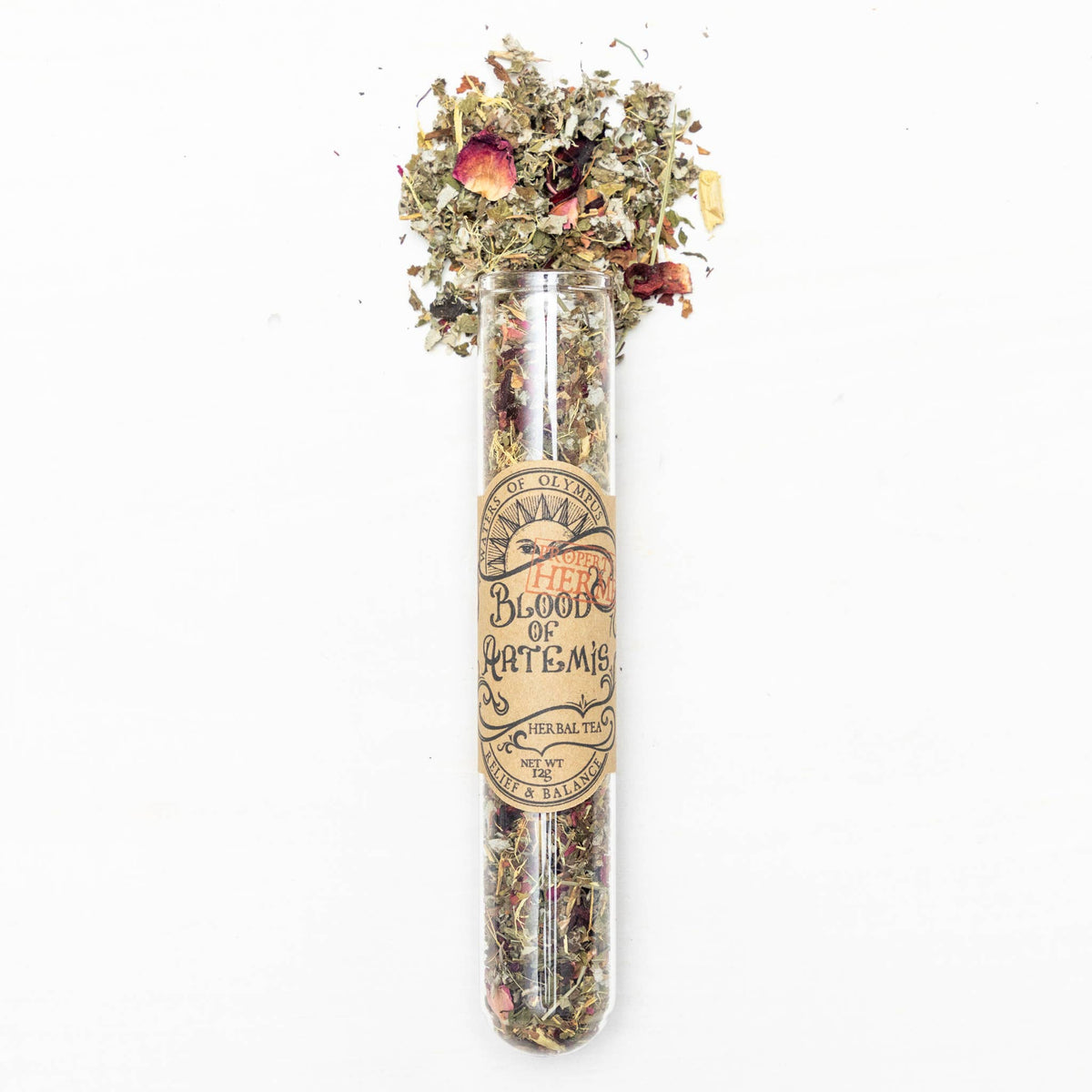 Clear glass tube with dried herbs and flowers on a white background