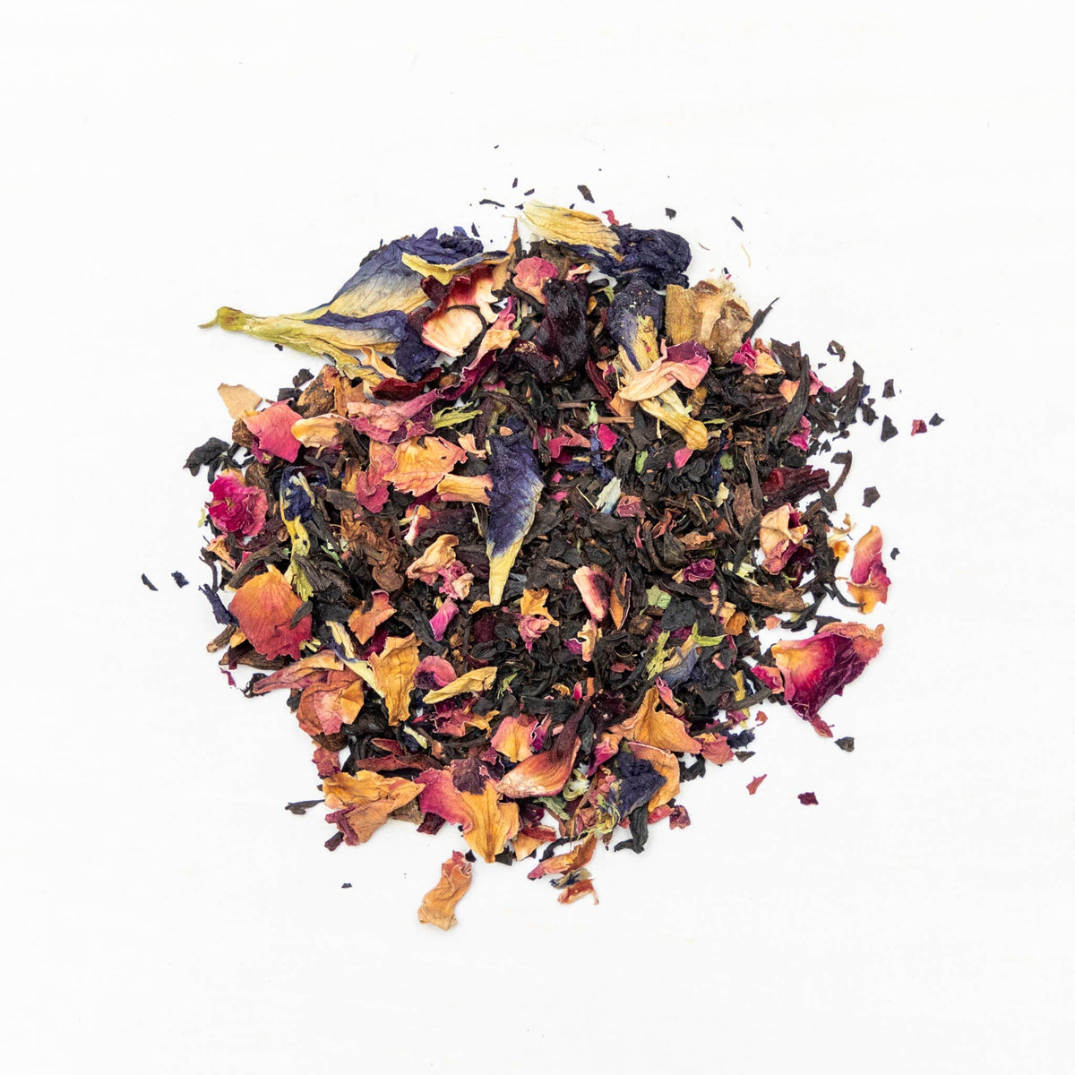 Colorful assortment of dried tea leaves on a white background